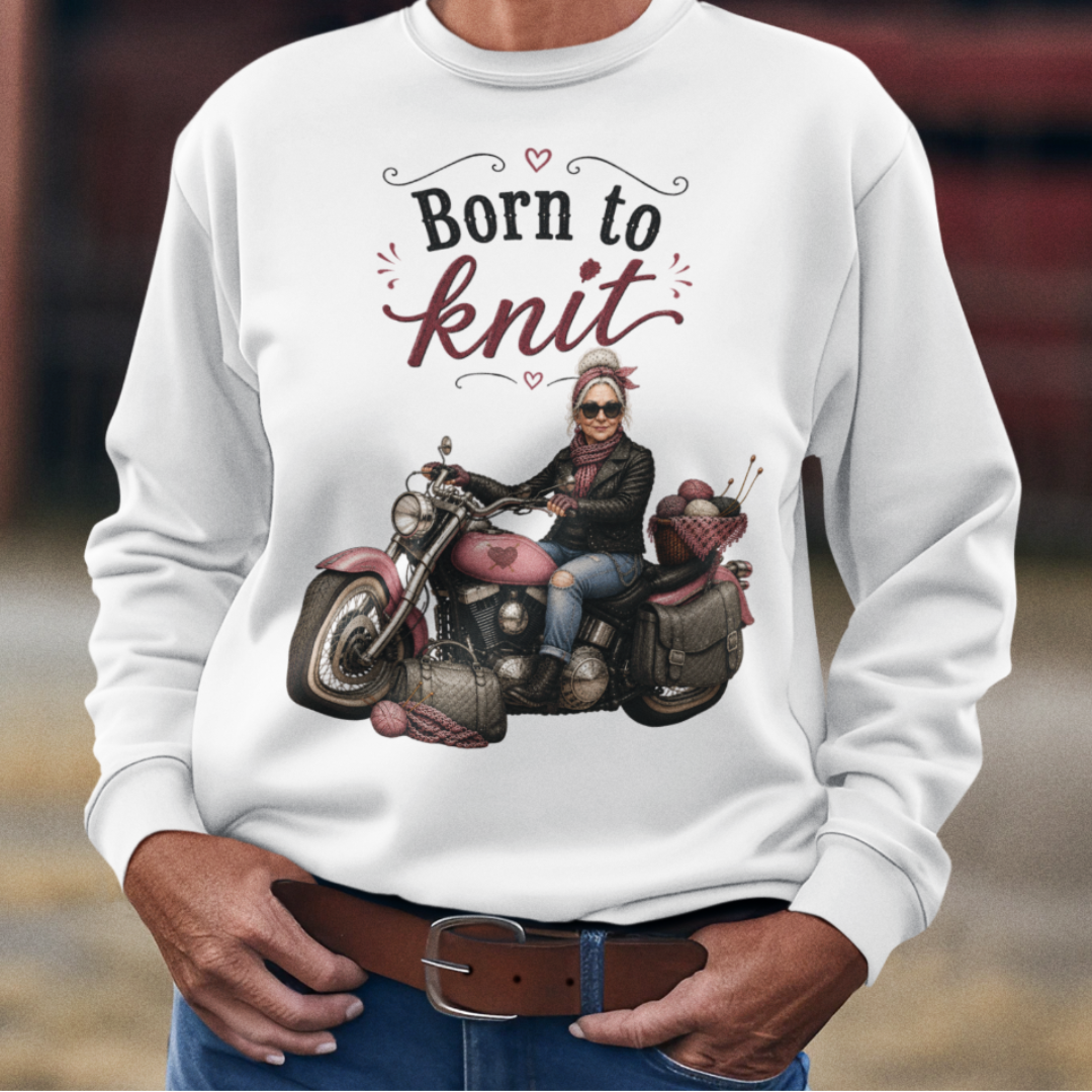 Woman wearing a white sweatshirt with a graphic and text, standing in an outdoor setting.