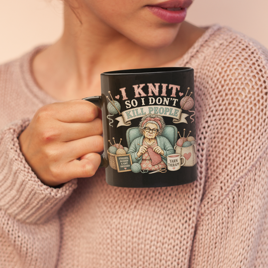 Woman holding a mug with a knitting-themed design against a plain background