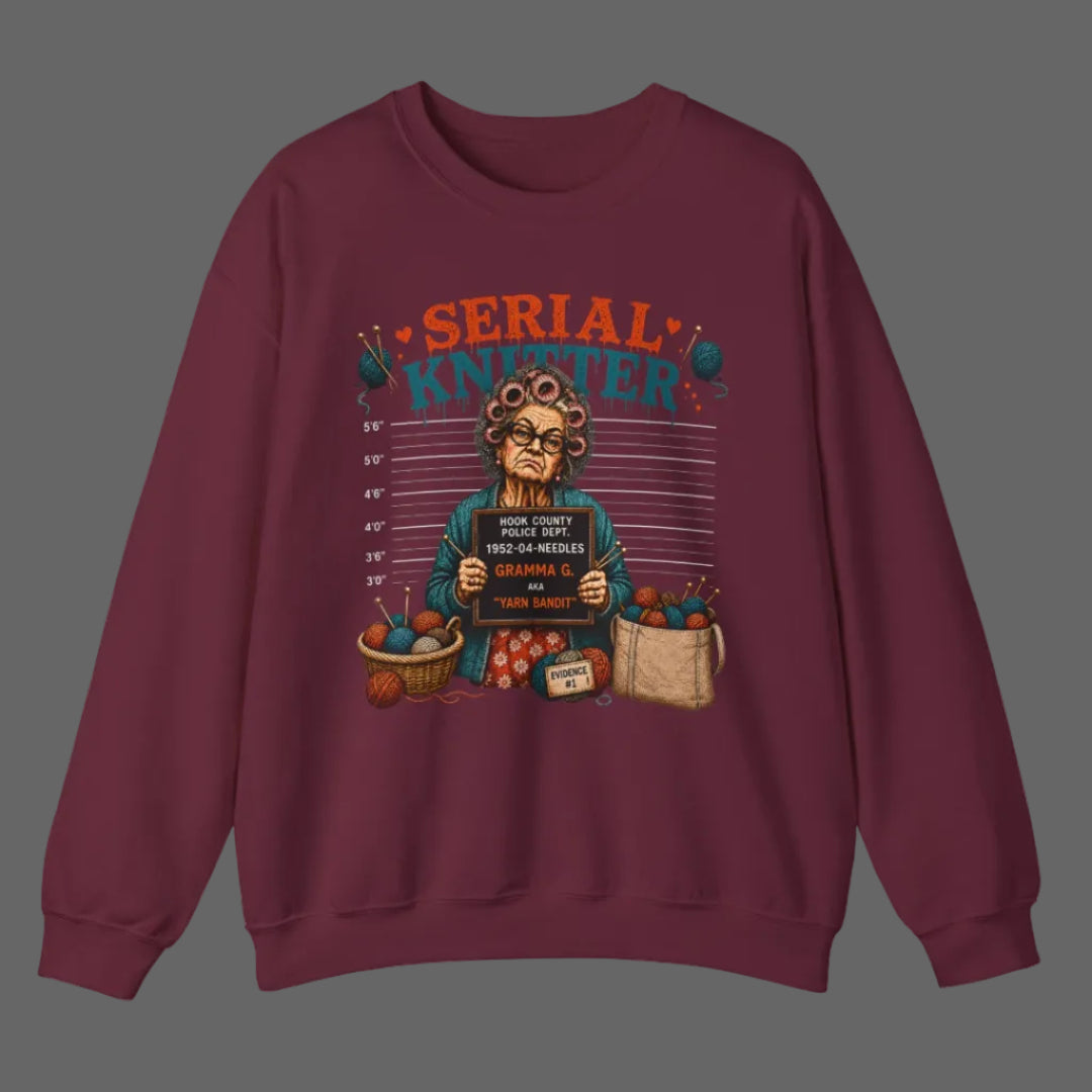 Maroon sweatshirt with a graphic design of an elderly woman holding a sign and surrounded by groceries on a white background.