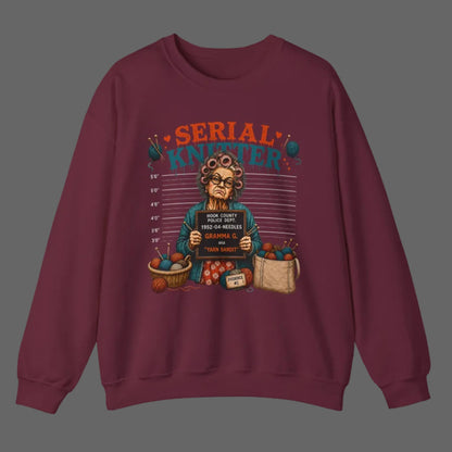 Maroon sweatshirt with a graphic design of an elderly woman holding a sign and surrounded by groceries on a white background.