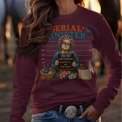 Woman wearing a cowboy hat and graphic sweatshirt with horses in the background