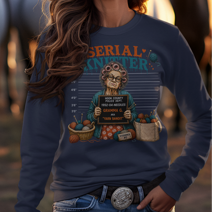 Woman wearing a cowboy hat and graphic sweatshirt with horses in the background