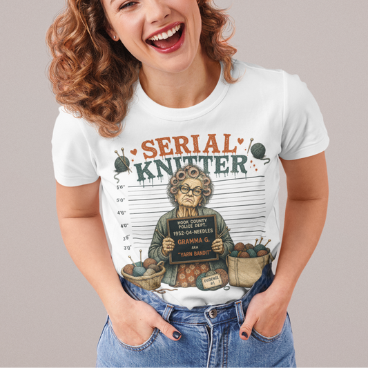 Person wearing a 'Serial Knitter' t-shirt with a graphic design on a plain background